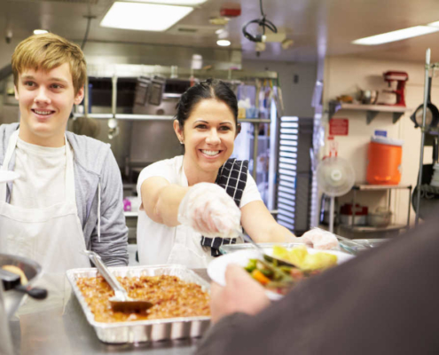 Man and woman volunteers serving food