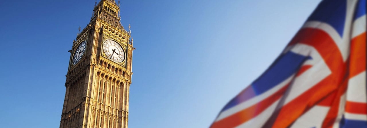 UK flag blowing in the wind with Big Ben in background